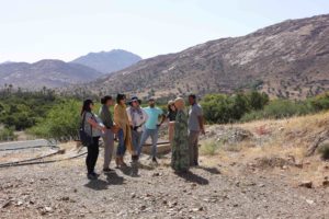 A crew of citizen storytellers listens to Rachina Boussine explain the history and purpose of Cooperative Tifouine Ameln in Tafroute, Morocco